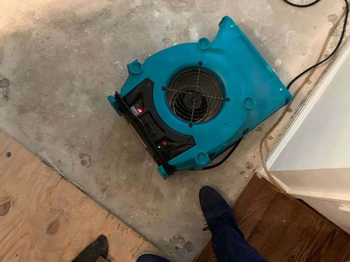 Air mover drying subfloor during Leak Detection & Repair in La Vista